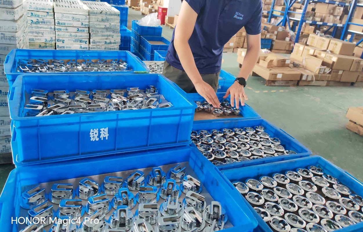 Reaking factory worker inspecting industrial cabinet locks — quality control for Belt and Road infrastructure projects