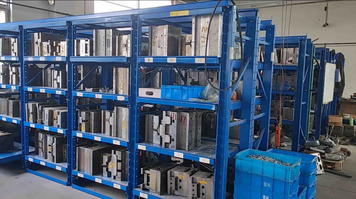Reaking in-house die-casting mold warehouse with precision zinc alloy lock molds on blue shelving at Shengzhou Reacoo factory